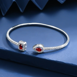 Adjustable silver bangle with sparkling micro-pave diamonds and red teardrop gems