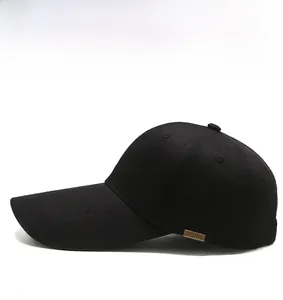 Detail view of the black baseball cap showing the extended brim and SPORT metal buckle