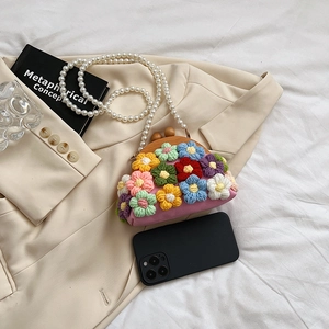 Pink handmade crochet shell bag with 3D floral accents and pearl chain strap