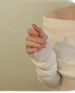 Detailed view of silver and gold S925 sterling silver minimalist round sequin bracelets