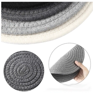Macro detail of hand-woven cotton cord coasters showing texture and flexible durability
