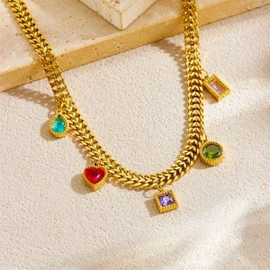Gold stainless steel necklace with five colorful geometric gemstone charms on stone base