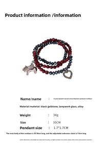 Detail of multi-layer beaded bracelet with silver elephant and heart charm accents