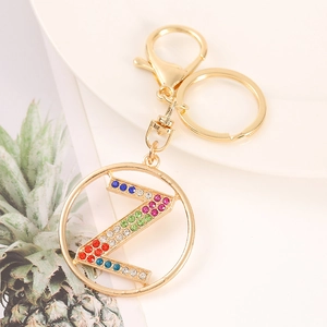 Macro detail of golden metal keychain with letter Z and colorful rhinestones