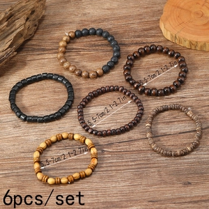 Detailed view of 6-piece men's beaded bracelet set with wood beads on a rustic background