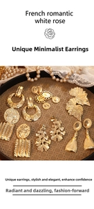 Detail view of vintage gold leaf earrings and textured metal studs in romantic french style