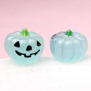 Macro shot of 3D glowing blue pumpkin figurines for Halloween DIY crafts and decorations
