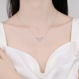 Elegant S925 sterling silver hollow heart necklace with diamonds on a model