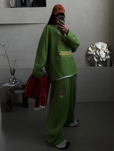 Full body selfie of a green streetwear tracksuit with wide leg pants and NYC baseball cap