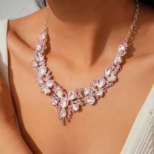 Elegant silver fan-shaped necklace with pink and clear crystals on a model