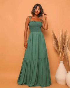 Detail of the elegant dark green maxi dress with spaghetti straps and pleated bodice