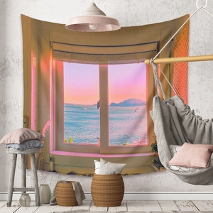 Detail view of sunset ocean scenery tapestry hung in a cozy minimalist room setting