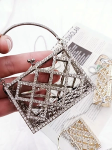 Macro detail of silver geometric cutout evening bag featuring sparkling rhinestone inlay