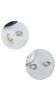 Detail of vintage silver smile face earrings with chain texture in creative circular frames
