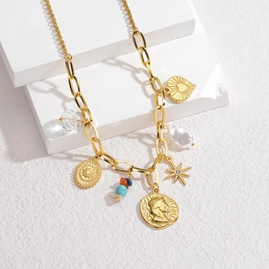 Detailed shot of 18K gold plated thick chain necklace with baroque pearl and mixed charms