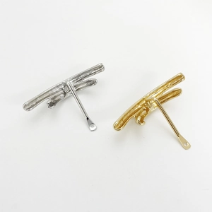 Minimalist dragonfly metal hair accessories in gold and silver finishes on white background