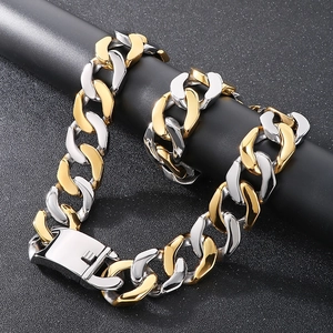 Detail of two-tone gold and silver Cuban link chain with secure clasp on black display