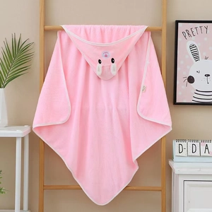 Pink coral fleece hooded baby towel with cute animal ears hanging on a wooden rack