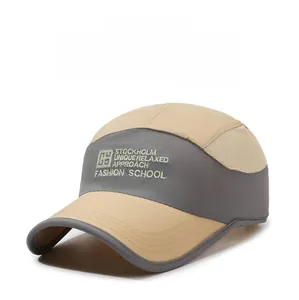Detail of khaki and grey mesh panel baseball cap with embroidered Stockholm typography