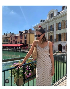 Close-up of beige floral sundress with button-front detail in a scenic outdoor setting