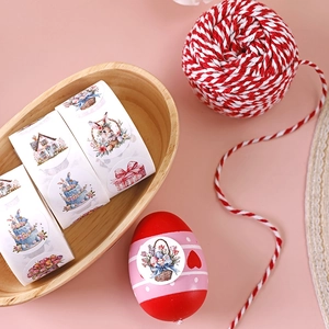 Close-up of Easter stickers with rabbits and flowers on a decorative red egg