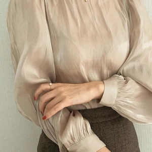 Elegant champagne satin blouse with puff sleeves and silver opal ring accessory