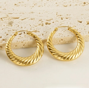 Detailed macro view of 18K gold plated twisted rope hoop earrings with textured finish