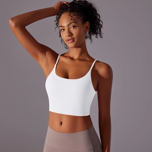 Detail of white thin strap yoga top with U-neck design and matte athletic fabric