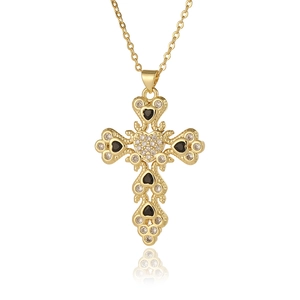 Detailed view of a gold cross pendant necklace featuring black heart stones and clear zircons