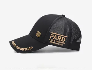 Detail view of gold embroidery and metal plaque on black mesh trucker baseball cap
