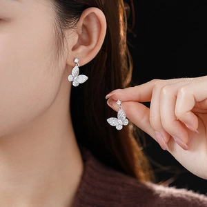 Detailed view of elegant silver butterfly earrings with sparkling cubic zirconia stones