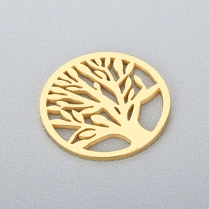 Golden hollow Tree of Life stainless steel necklace pendant on textured grey background