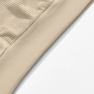 Close-up of beige corduroy sweatshirt ribbed cuffs and high-density knit fabric texture