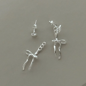 Close-up of S925 sterling silver bow earrings with visible material hallmark engraving