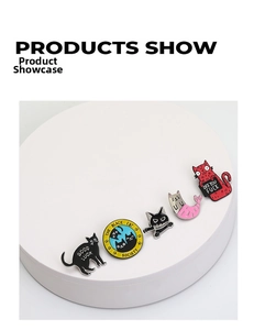 Set of five creative cat enamel pins in various poses and colors on a white display pedestal