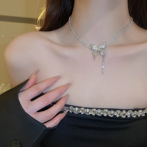 Elegant silver butterfly tassel necklace with sparkling crystals on a female model