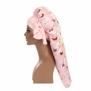 Detail of pink butterfly print satin bonnet with elastic band and side bow for long hair