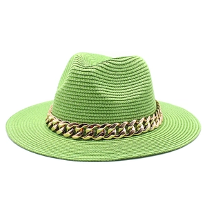 Green woven boater straw hat featuring a chunky gold chain band on a white background