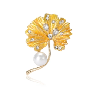 Elegant ginkgo leaf brooch in gold finish with sparkling crystals and a white pearl accent