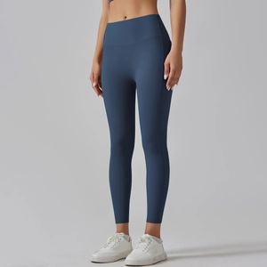 Detail view of high-waisted navy blue yoga pants with seamless texture and lift effect