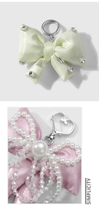 Detail of satin bow keychains with sparkling rhinestones, pearls and crystal beads