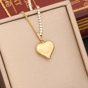 Close-up of gold heart pendant necklace with rhinestones displayed in a gift box