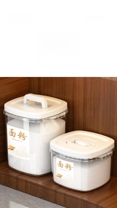Airtight kitchen storage containers with handles for flour and rice storage on a shelf