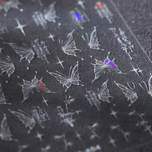 Holographic butterfly and star nail art stickers with white silk print on dark textured base