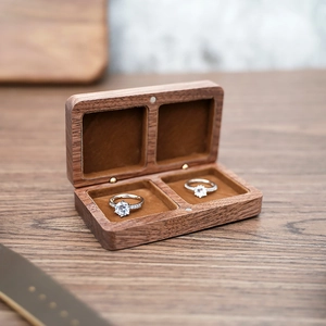 Top-down macro view of double-slot black walnut wood jewelry box with velvet lining