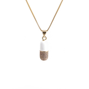 Gold pill capsule pendant necklace with white enamel and sparkling zircon pavé on box chain