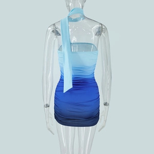 Detail view of back of a gradient blue bodycon dress with ruching and long ribbon detail