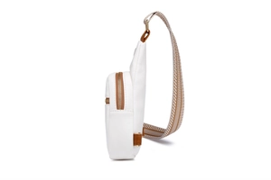 Side view of white faux leather chest bag with brown geometric patterned woven strap