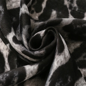 Close-up of leopard print scarf fabric showing soft texture and detailed animal pattern