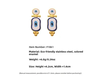 Detail of evil eye drop earrings in blue enamel and gold-plated stainless steel